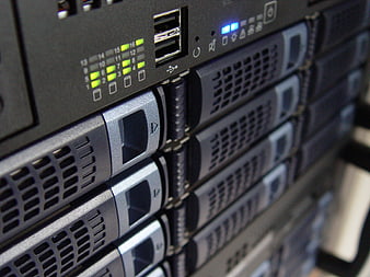 Close-up of server rack with hard drive bays and status lights