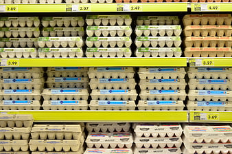 Supermarket Shelves Stocked With Cartons Of Fresh Eggs