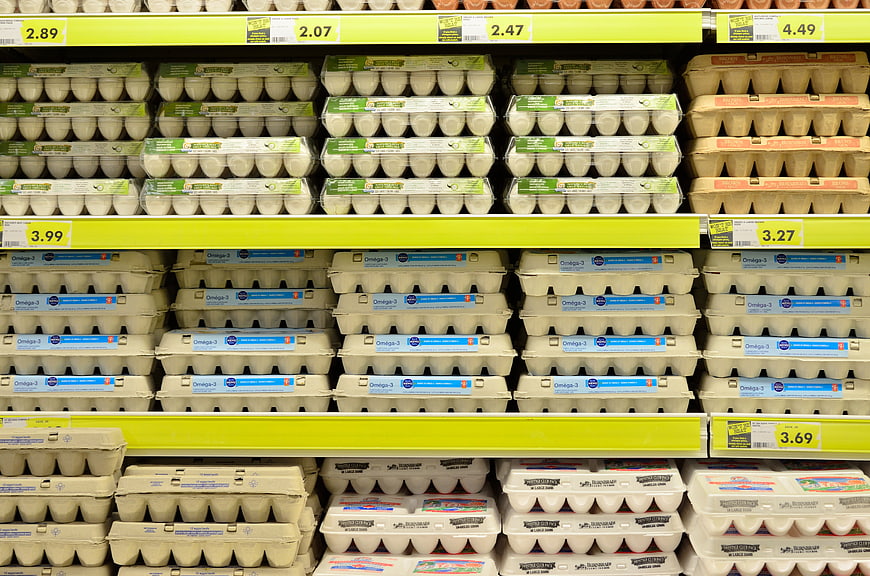 Supermarket Shelves Stocked With Cartons Of Fresh Eggs
