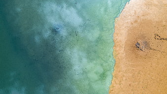 Aerial View of Turquoise Sea Meeting Sandy Beach