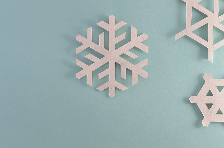 Minimalist Paper Snowflakes on Blue Background