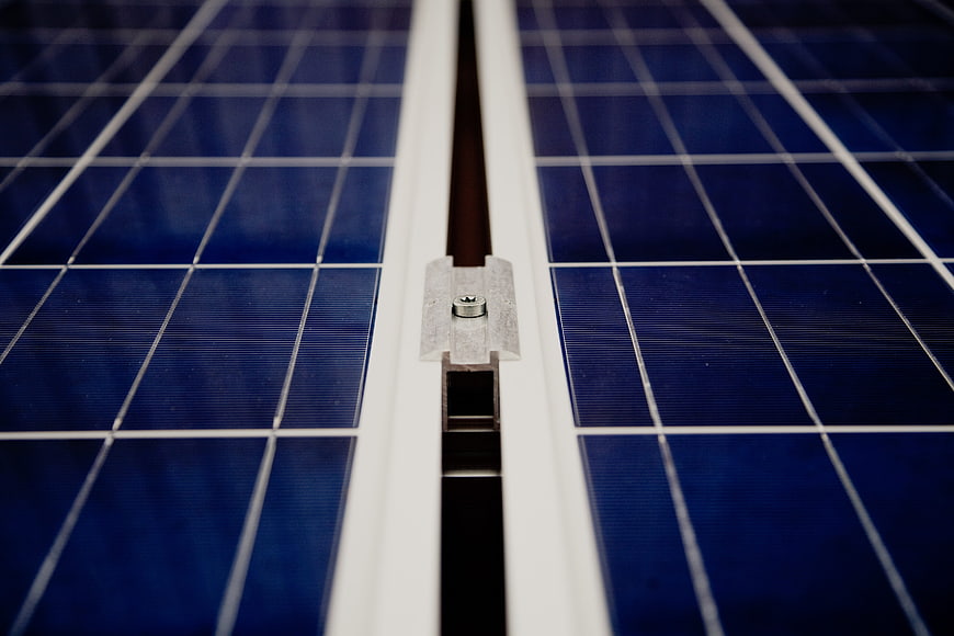 Close-up of solar panel cells and metal mounting bracket
