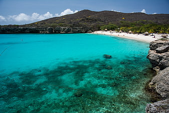 Turquoise Caribbean Beach with Clear Water and Rocky Shore