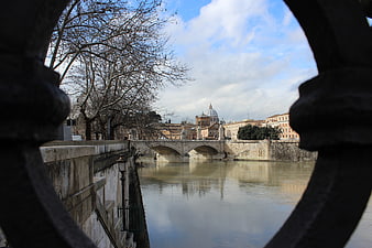 View of St. Peter's Basilica through a bridge railing in Rome