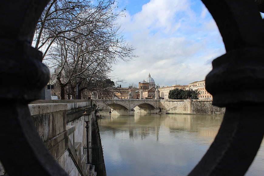 View of St. Peter's Basilica through a bridge railing in Rome