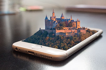 Smartphone displaying 3D holographic castle on screen
