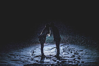 Silhouette of Couple Kissing in Snowy Night