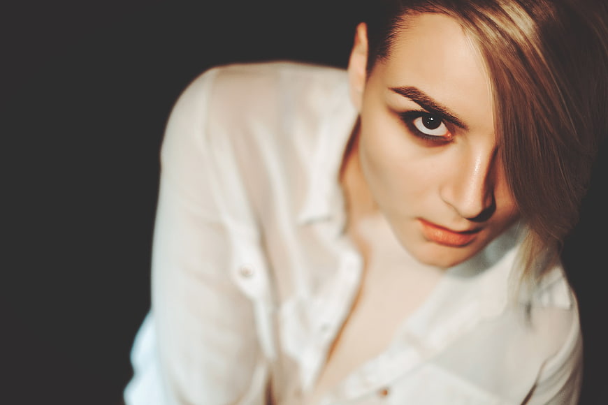 Dramatic Portrait of Woman Looking Up in White Shirt