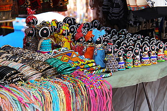 Colorful African Beaded Dolls and Jewelry at a Market Stall