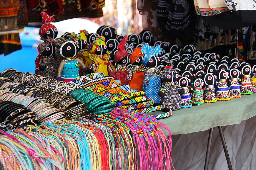 Colorful African Beaded Dolls and Jewelry at a Market Stall