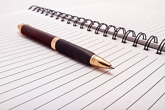 Gold and black pen on spiral notebook