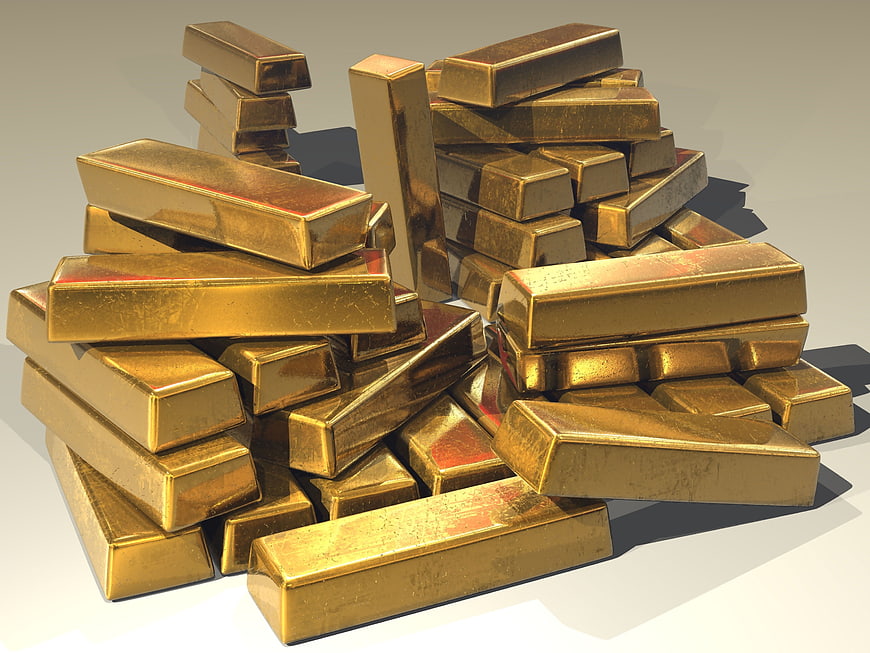 3D Render of Piled Gold Bars on White Background