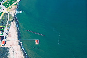 Aerial view of coastal pier and turquoise ocean water