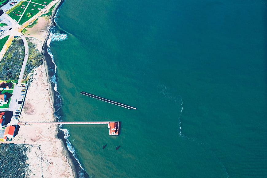 Aerial view of coastal pier and turquoise ocean water