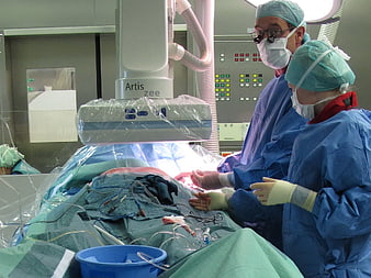 Surgeons performing minimally invasive surgery in operating room