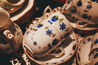 Vintage porcelain teacups with blue floral patterns and gold trim