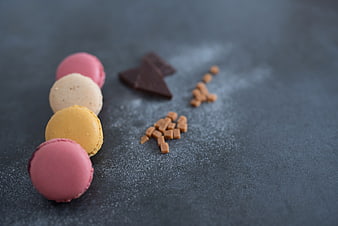 Colorful Macarons and Chocolate on Dark Slate Background