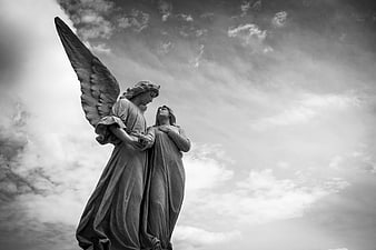 Black and White Angel Statue with Cloudy Sky Background