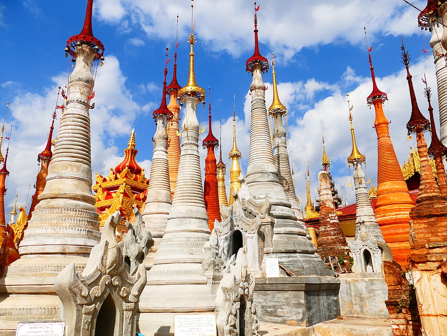 Colorful Buddhist Stupas in Myanmar Against Blue Sky