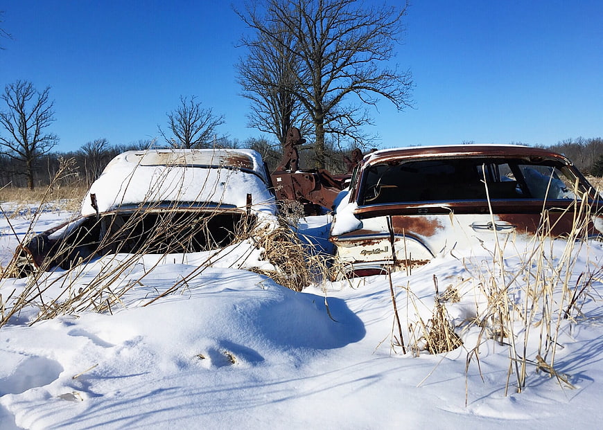 Abandoned Rusty Cars Buried in Snow Winter Landscape