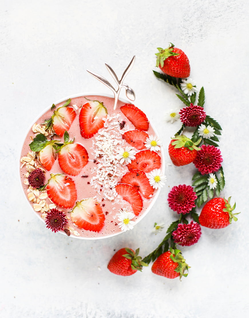 Top View Strawberry Smoothie Bowl with Fresh Fruit and Flowers
