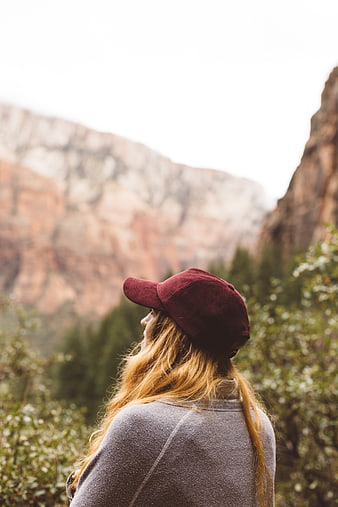 Woman in Maroon Cap Looking at Mountain Landscape