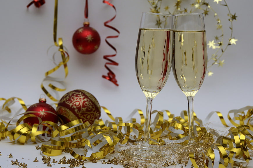 Champagne Toast with Christmas Ornaments and Gold Streamers