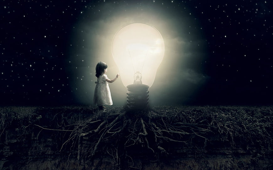 Little girl touching giant glowing lightbulb with roots in dark sky