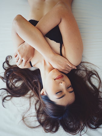 Woman Sleeping Peacefully in Black Lingerie on White Bed