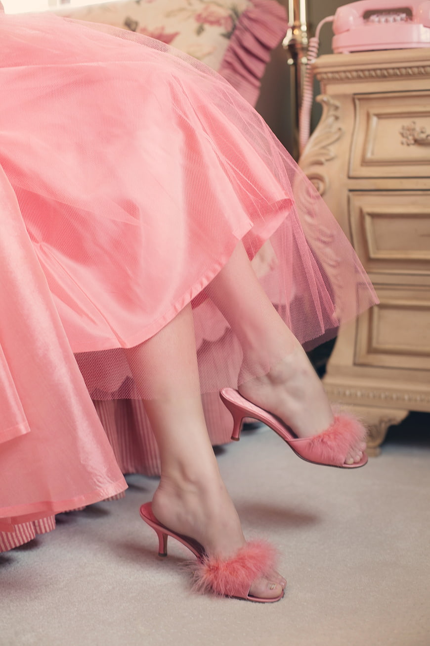 Woman in pink tulle dress and feathered heels