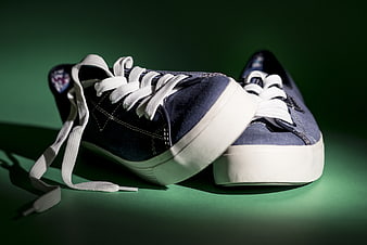 Blue Canvas Sneakers on Green Background
