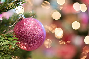 Close-up of Glittery Pink Christmas Ornament on Tree