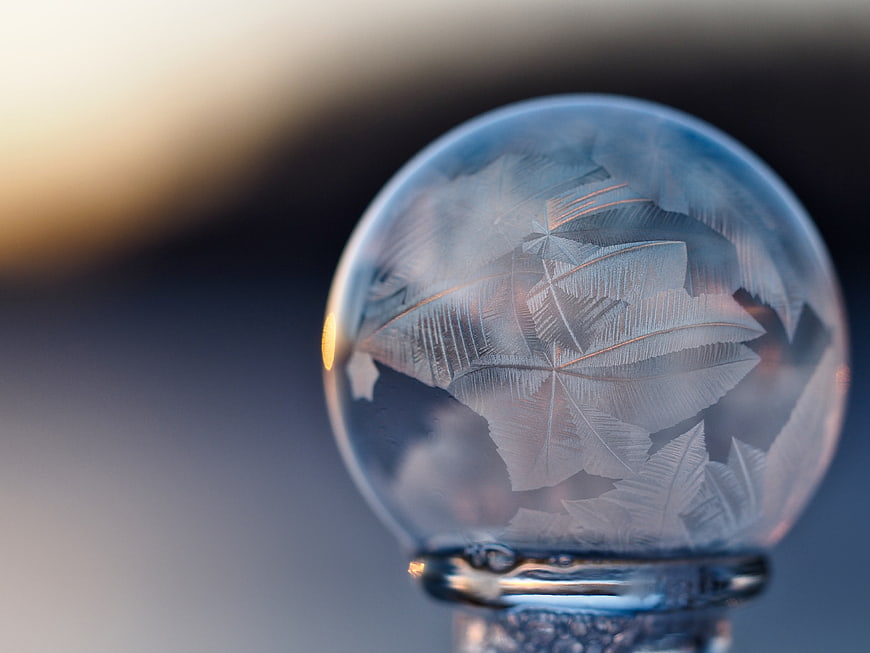Frosted glass ornament with leaf pattern and bokeh background