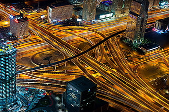 Aerial Night View of Dubai Highway Interchange with Light Trails