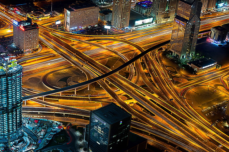 Aerial Night View of Dubai Highway Interchange with Light Trails