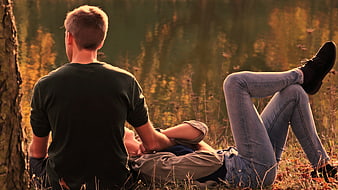Romantic couple relaxing outdoors in golden hour light