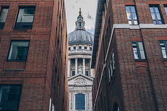 St Paul's Cathedral framed by modern brick buildings in London