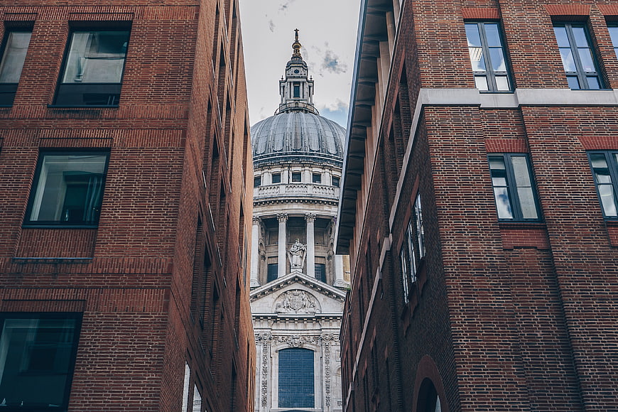 St Paul's Cathedral framed by modern brick buildings in London