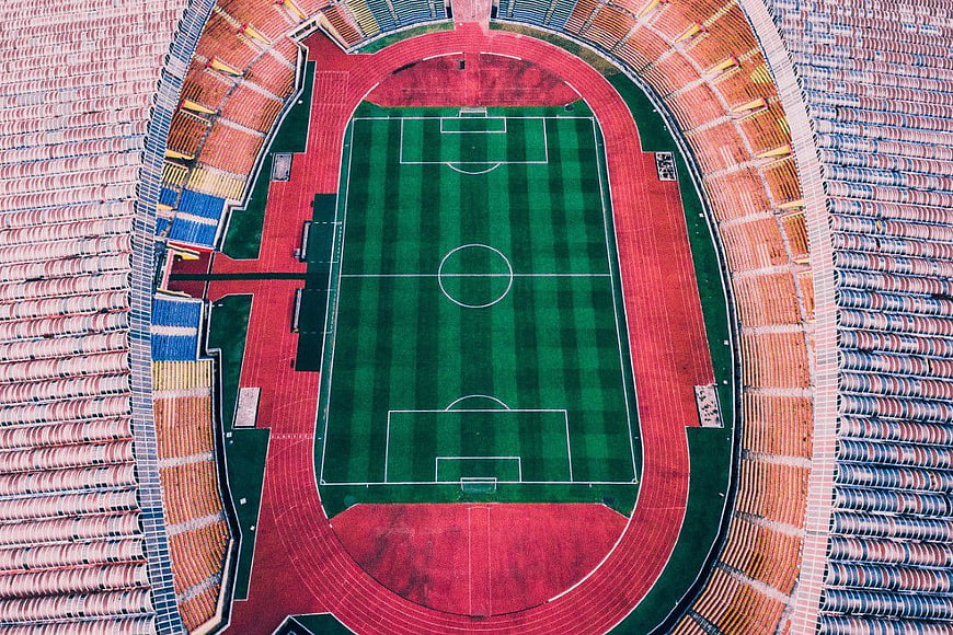Aerial View of Empty Soccer Stadium with Green Pitch