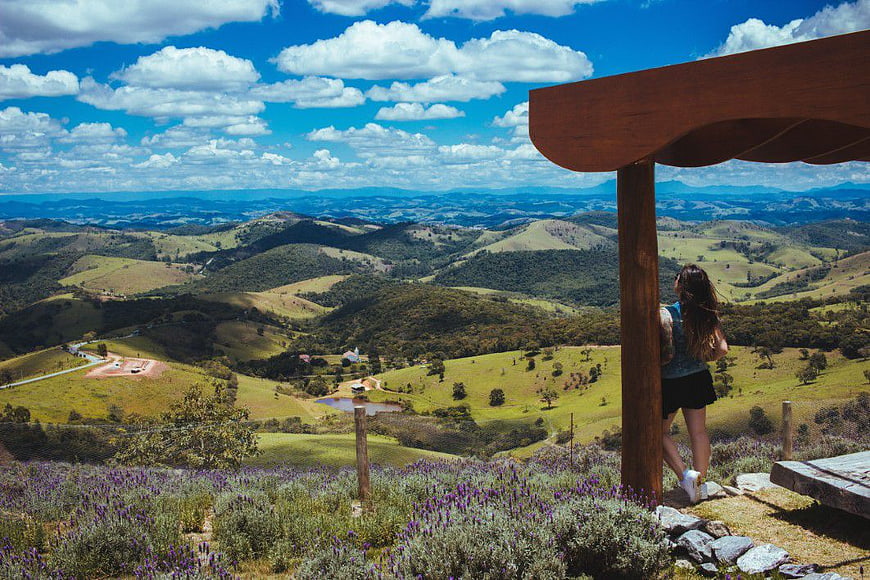 Woman Looking at Scenic Rolling Hills and Blue Sky