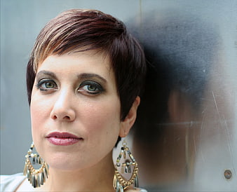 Portrait of woman with short hair and statement earrings