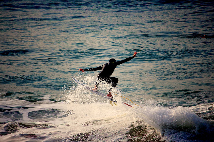 Surfer in Wetsuit Riding Wave with Splash