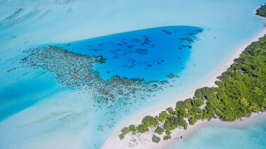 Aerial View of Turquoise Lagoon and Tropical Island Coastline