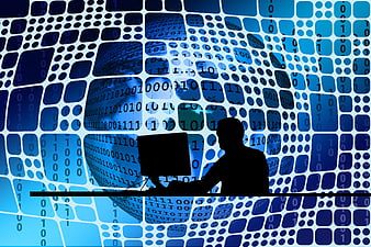 Silhouette of person working at computer with digital network background