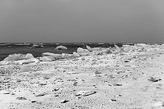 Black and white ice chunks on a frozen shoreline
