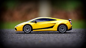 Yellow Lamborghini Model Car on Asphalt Road