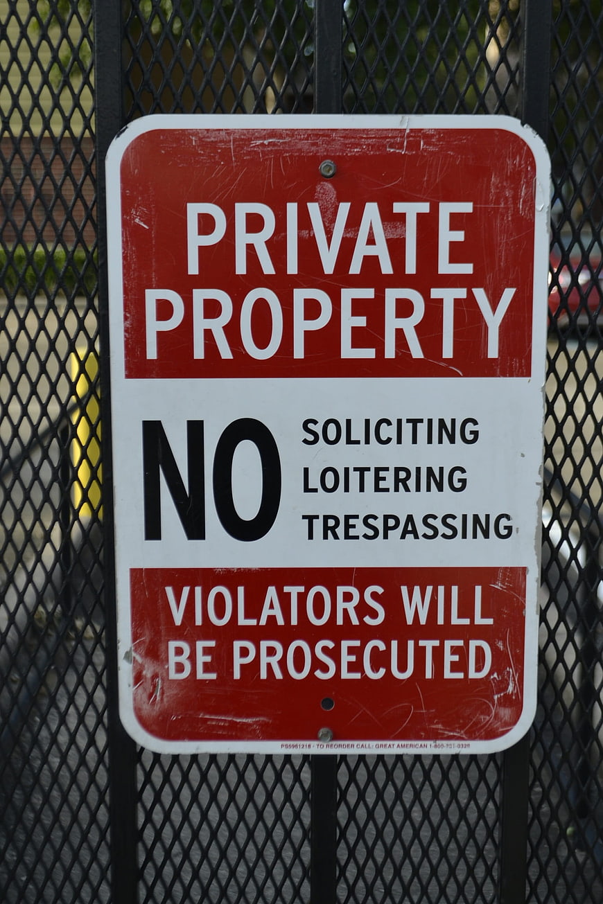 Private Property No Trespassing Sign on Metal Fence