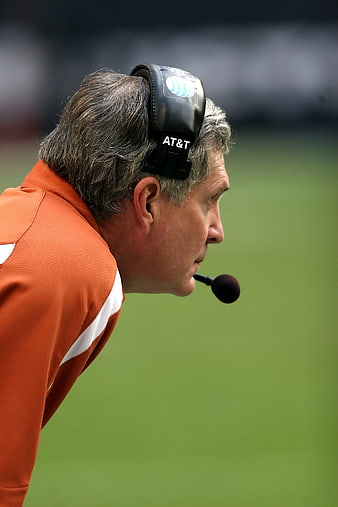 Profile of football coach wearing headset on field
