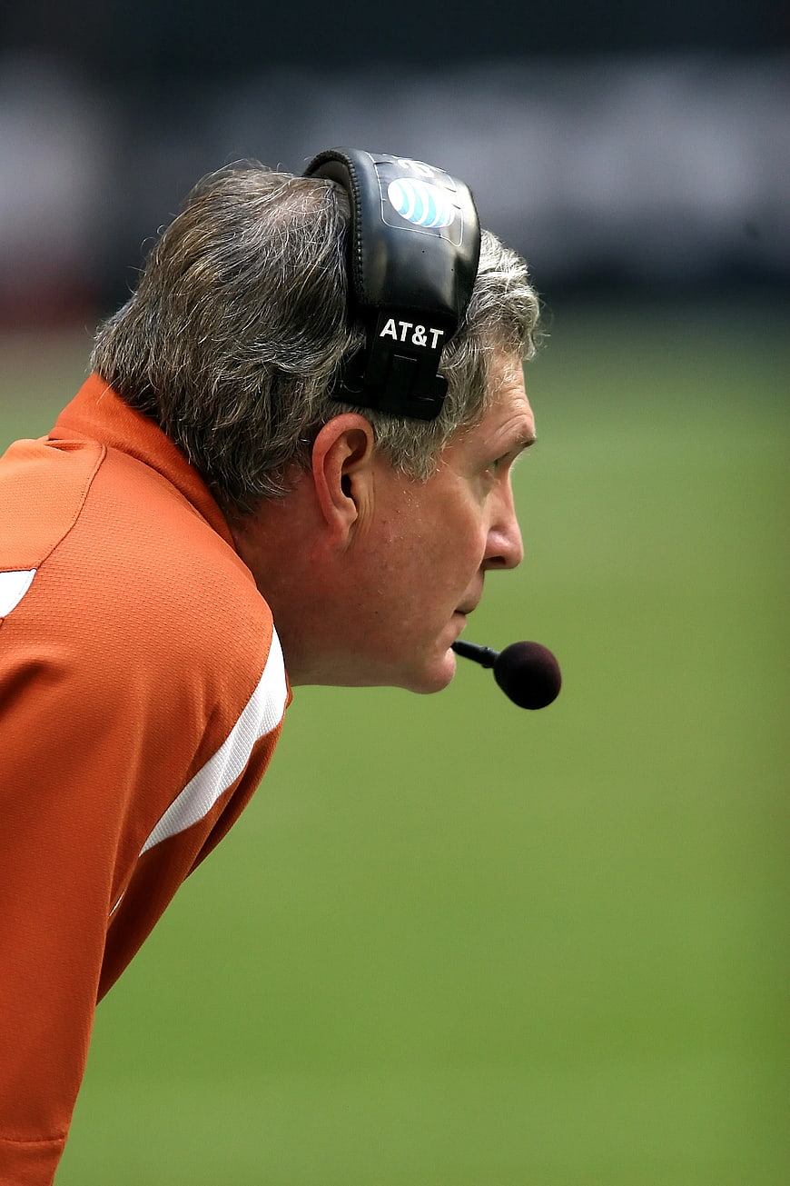 Profile of football coach wearing headset on field
