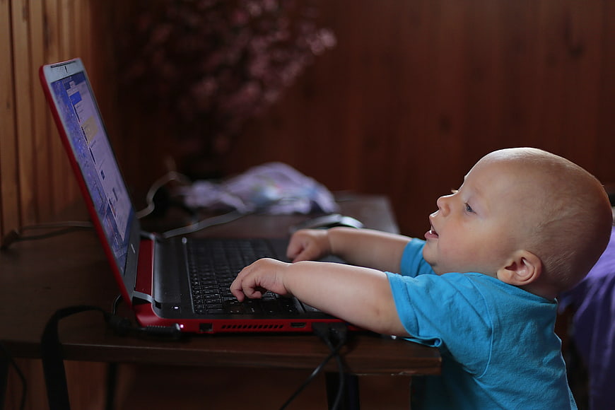 Baby Boy Using Laptop Computer at Home